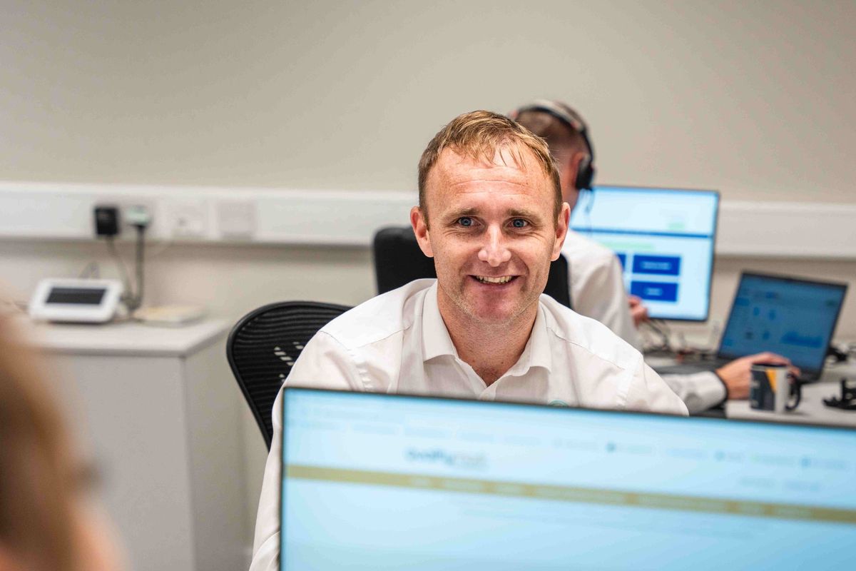 A technology professional working at a desktop workstation in an office